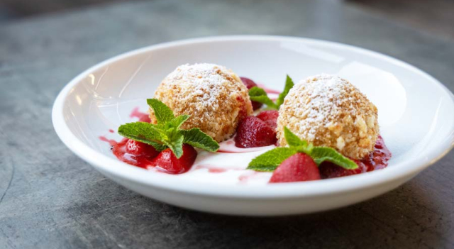 Cottage cheese dumplings, served with strawberry ragout and sweet sour cream