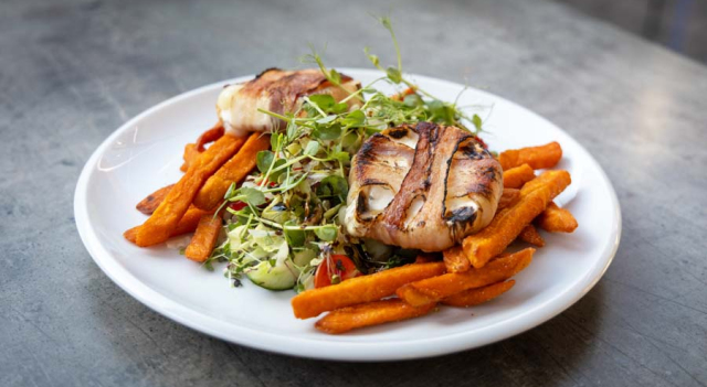 Grilled goat cheese wrapped in bacon, served with sweet potato fries and mixed green salad