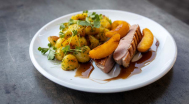 Duck breast, served with parsley potatoes and grilled peach